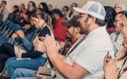 A group of students clapping.